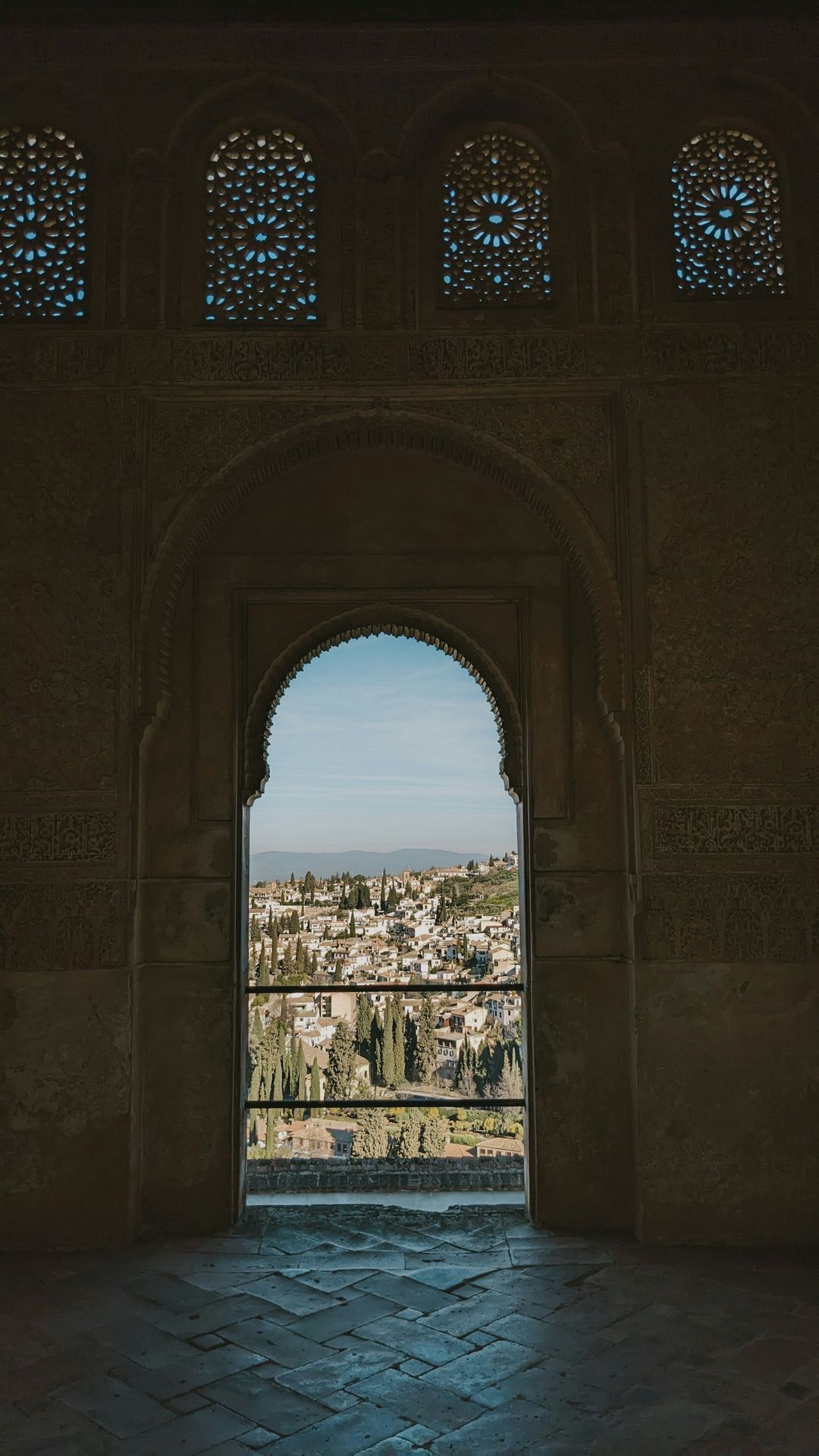 a view of a city through an arch in a building